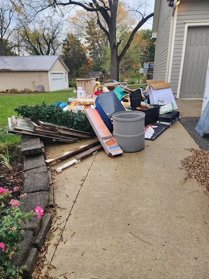 Dumpster being loaded with debris for Estate Cleanout Dumpster Rental in Robinson